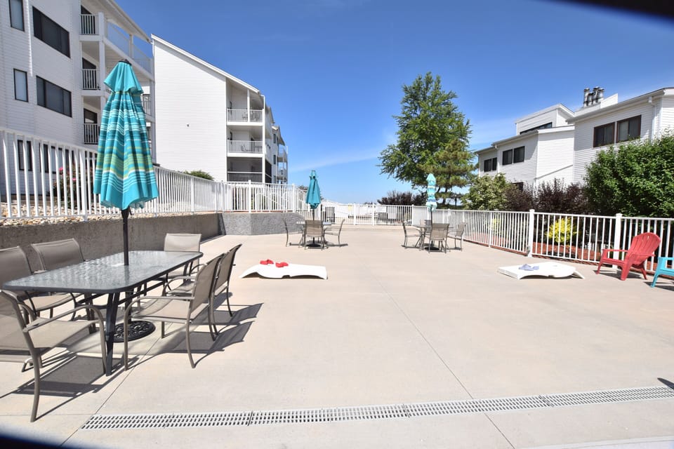 Large area around the pool to play bags or just get together.