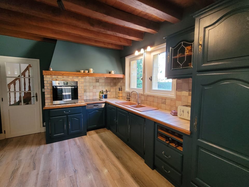 The well equipped kitchen has a dishwasher  large American style fridge/freezer