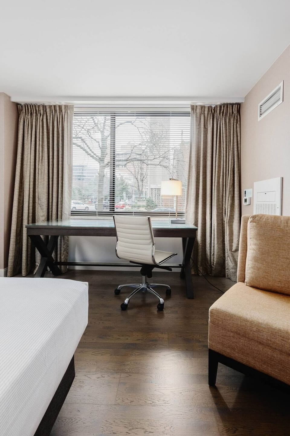 Catch up on work at a bright desk by the window.