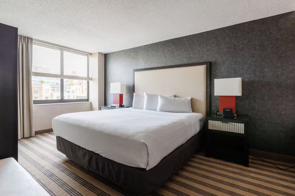 Unwind in a serene king bed after a busy day.