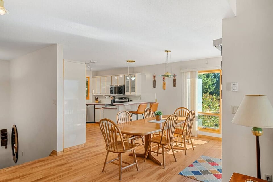 Dining area with a table 6 at the island and 2 at the kitchen island.