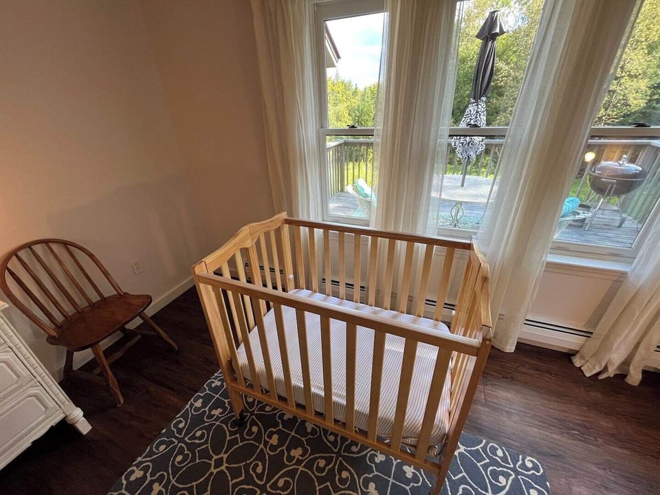 The wheeled crib may be collapsed for easy portability across the house.