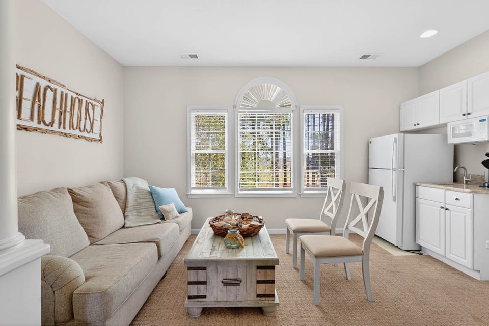 Cozy sitting room with sofa seating and a small kitchenette area.