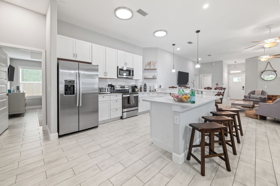 Open kitchen with full appliances and large island.