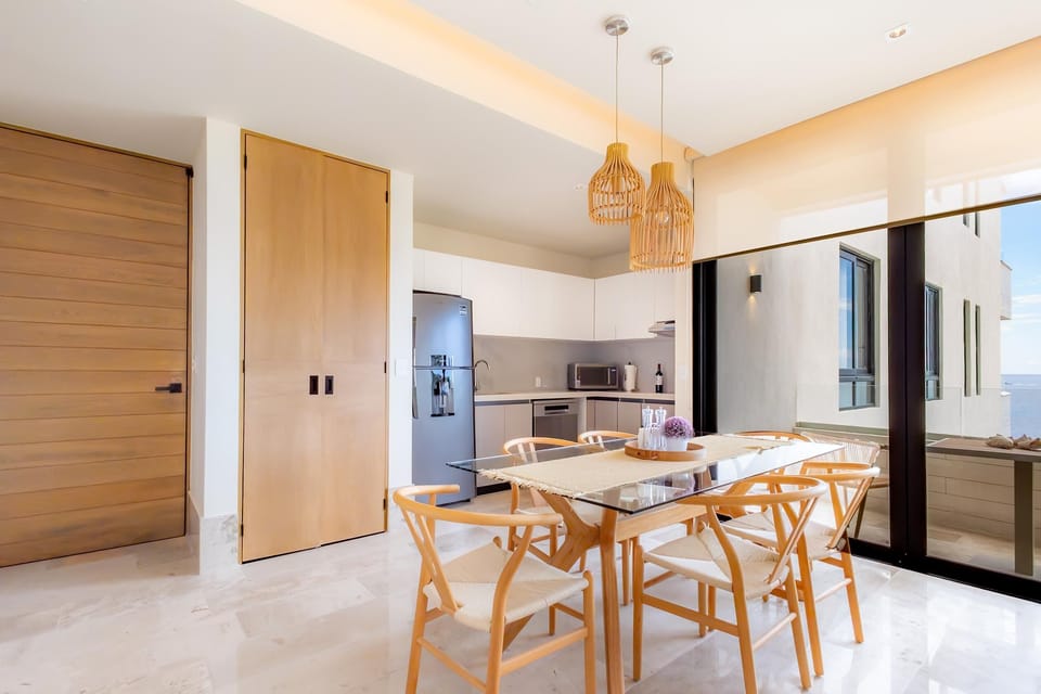 Bright dining area with modern kitchen and natural light
