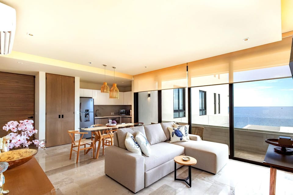 Sunlit living room with sea views and cozy seating