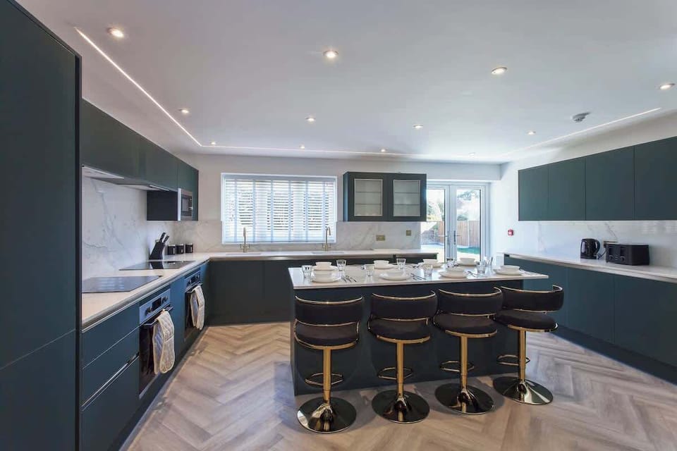 Spacious modern kitchen with breakfast bar seating — perfect for cooking, dining, and socializing.