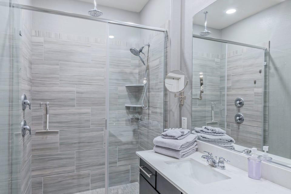En suite bathroom in the primary suite has a walk in shower for rinsing off after golfing, hiking or biking.