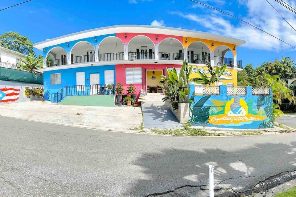 Discover the vibrant charm of our property's exterior! With its cheerful colors and inviting atmosphere, you'll feel the spirit of the island the moment you arrive.