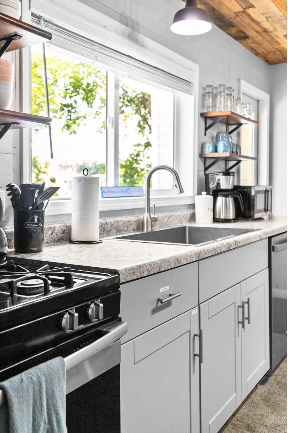 Full kitchen with stove/oven, fridge/freezer, dishwasher, sink, coffee maker and plenty of cooking utensils/pots&pans for a gourmet meal.