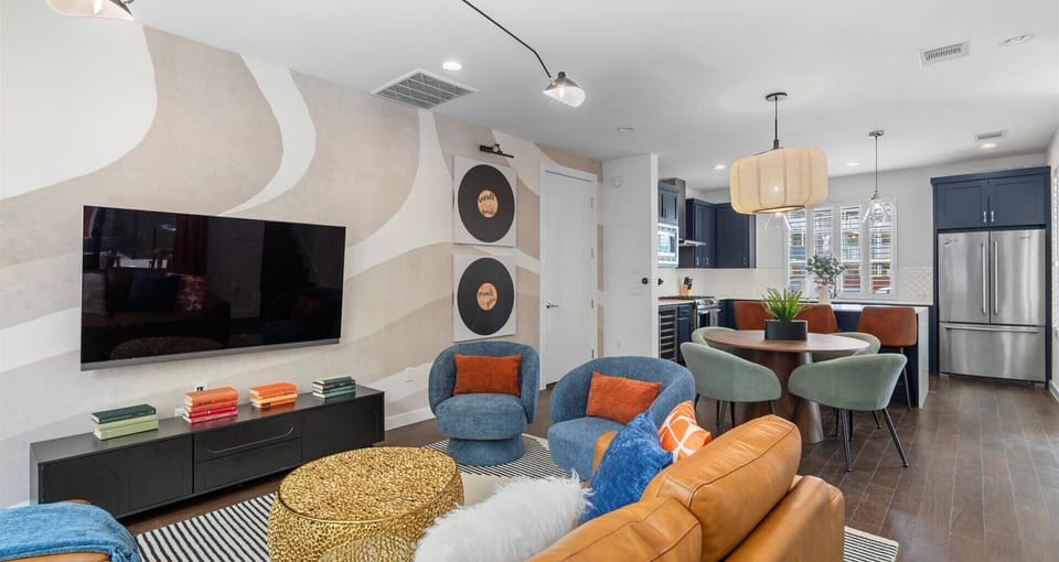 Bright living room with comfortable sofa, eclectic décor and smart TV