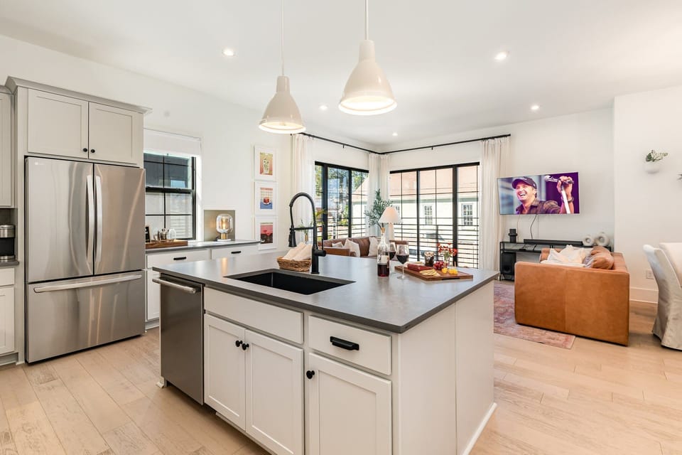 2nd Floor: Fully equipped kitchen with stainless-steel appliances and a kitchen island offering ample counter space and bar seating.