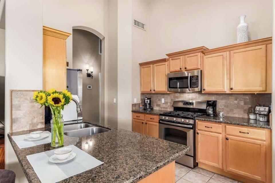 Fully stocked kitchen with modern appliances.