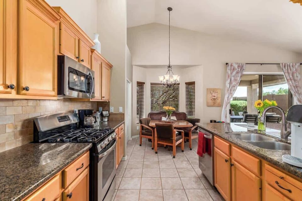 Fully stocked kitchen with modern appliances.
