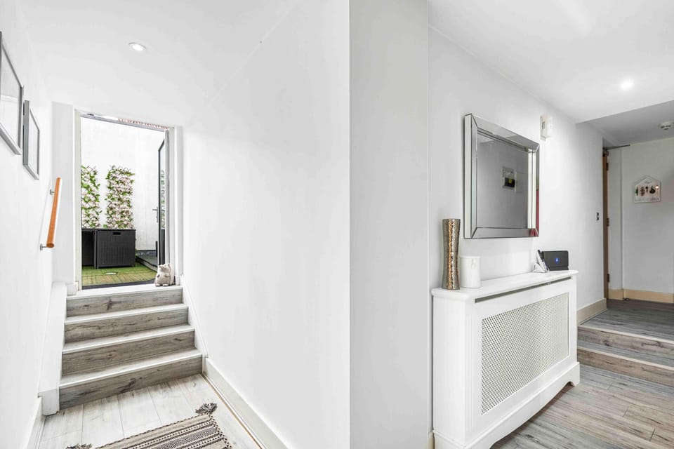 Hallway with stairs leading to exterior terrace area 