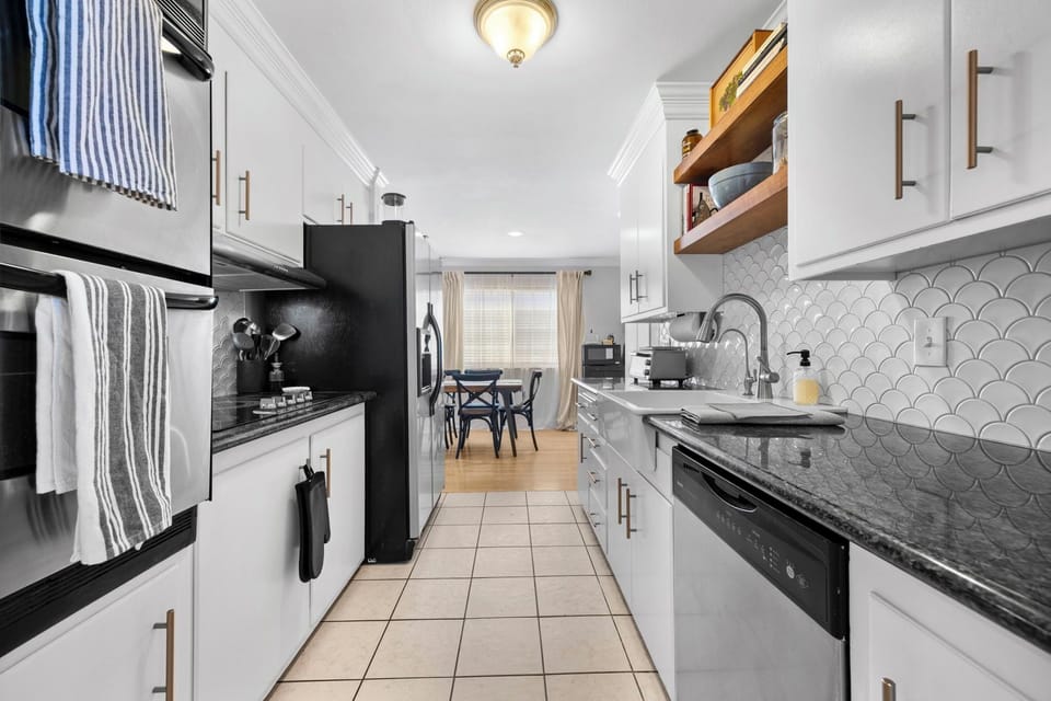 Updated, fully-equipped galley kitchen including farmhouse sink & dishwasher.
