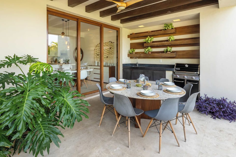 Luxury outdoor dining terrace with gourmet kitchen and indoor-outdoor living