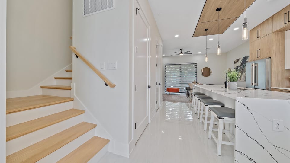 Staircase and elevator off the kitchen and dining area to access all levels of the home