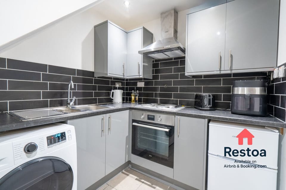 Fully equipped kitchen area with oven, hob and fridge, shared between 4 studios