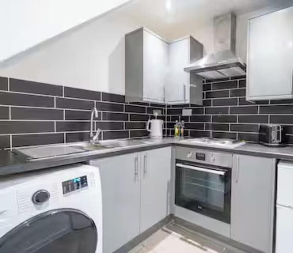 Fully equipped kitchen area with oven, hob and fridge, shared between 4 studios