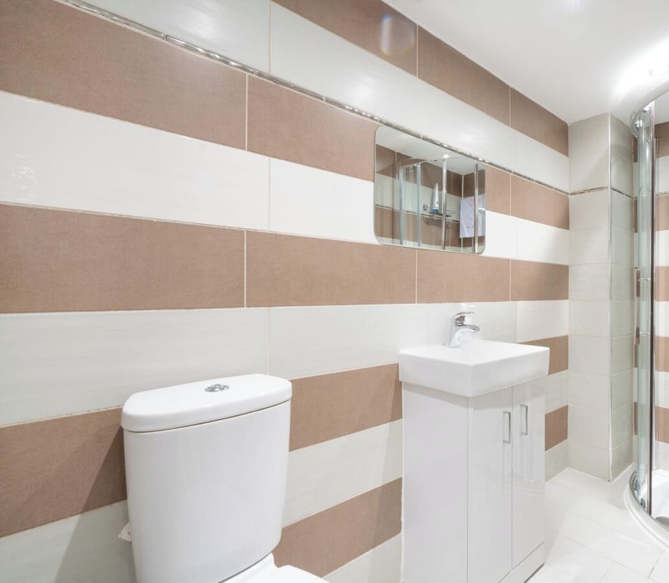 Contemporary bathroom with walk-in shower and striped tiling