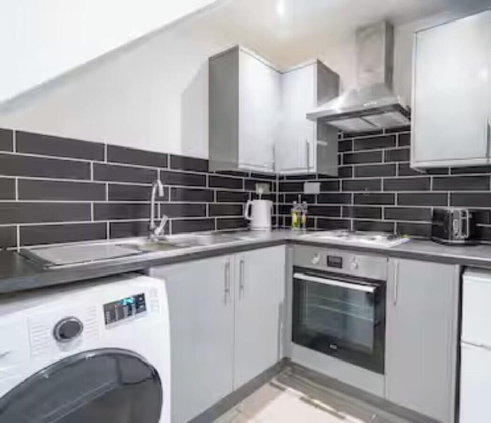 Fully equipped kitchen area with oven, hob and fridge, shared between 4 studios