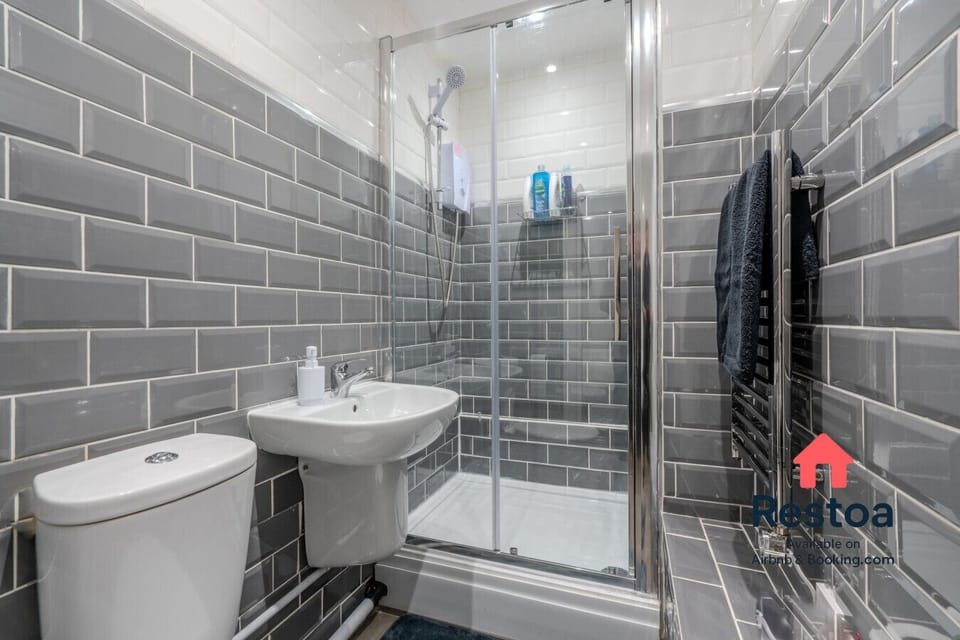 Stylish shower room with grey tiling