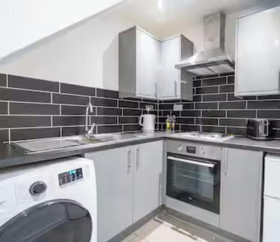 Fully equipped kitchen area with oven, hob and fridge, shared between 4 studios