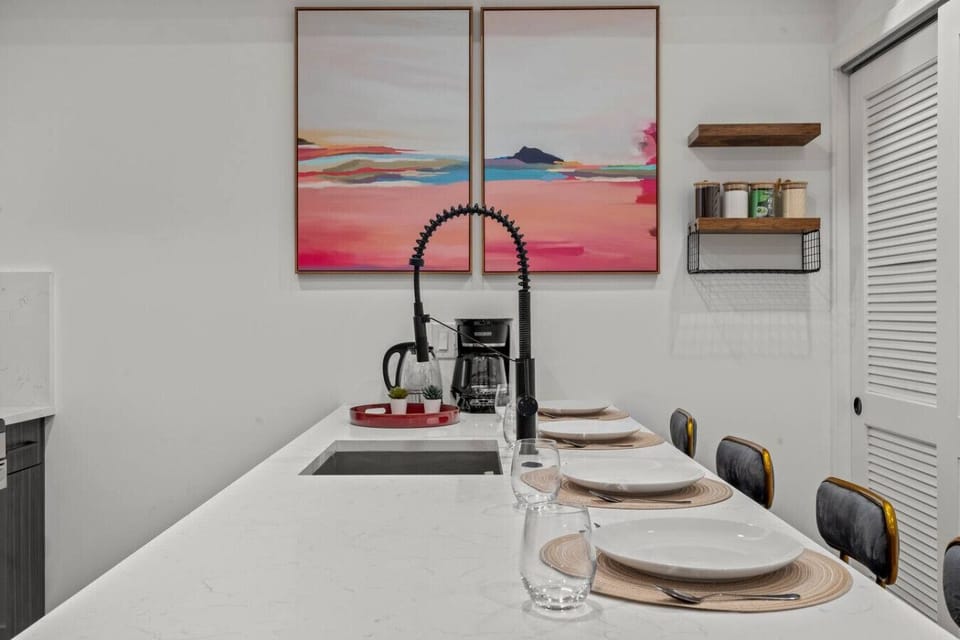 Cozy dining area with beautiful paintings as backdrop.