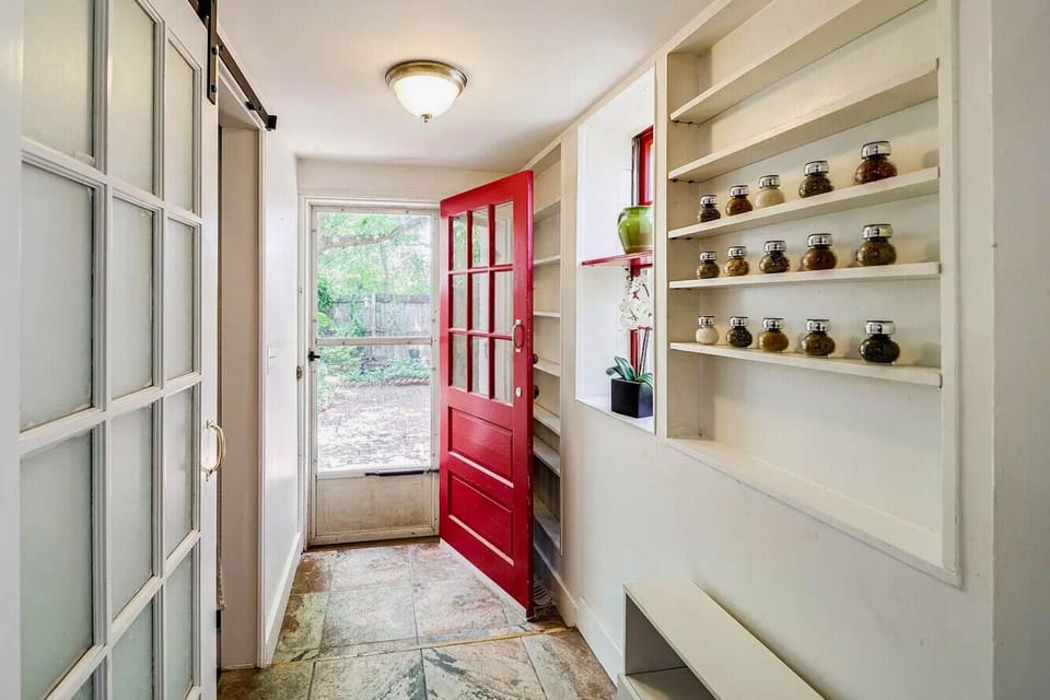 Rear door with access to the garden and parking
