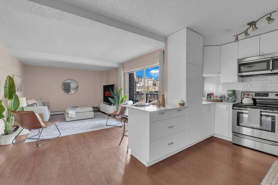 Inviting living room with a plush seating area and a 75-inch smart TV for elevated entertainment