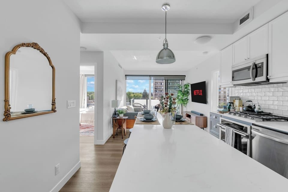 Gourmet kitchen bathed in natural light, complete with premium appliances, curated essentials, and a sleek island for dining or entertaining.