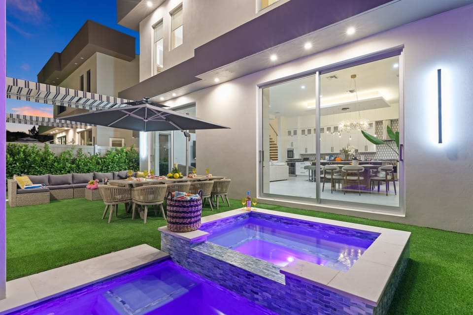 Evenings feel special with a glowing pool and spa, outdoor dining, lounge seating, and seamless indoor-outdoor flow from the main living area.