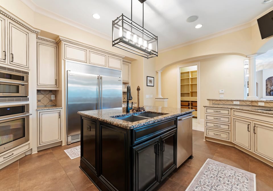 Fully stocked kitchen with island and bar seating.