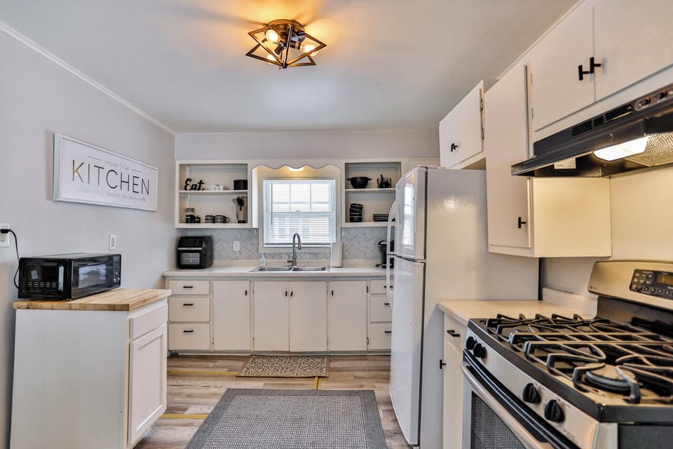 Spacious kitchen with full-size appliances, open shelving, and great natural light.