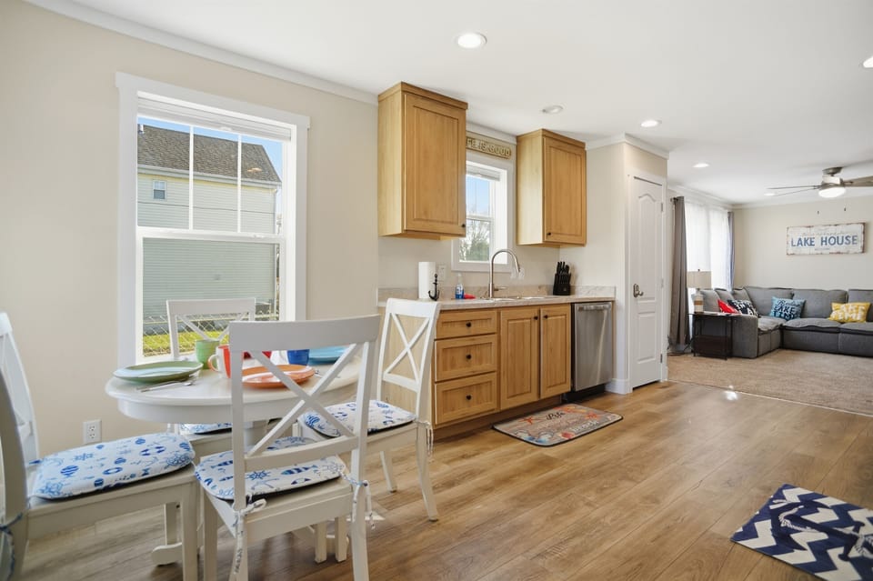 Open concept living area with dining, kitchen and living room all open.