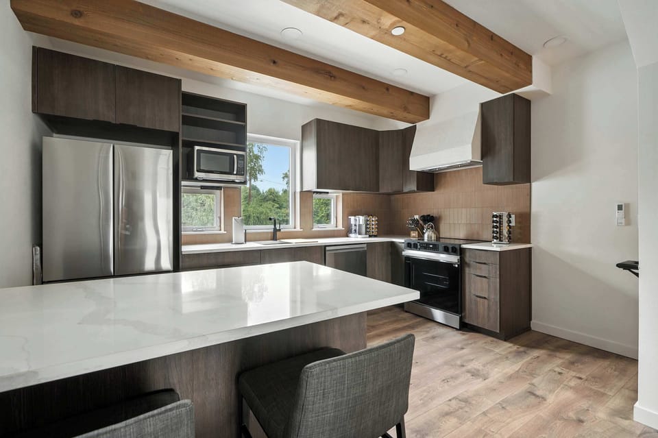 Kitchen with island and stainless appliances.