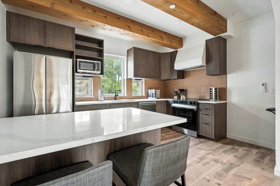Kitchen with island and stainless appliances.