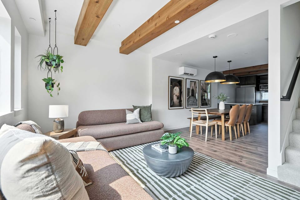 Living room open to dining and kitchen.