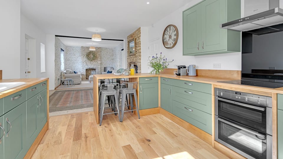At one end, the kitchen has an oven and hob, fridge/freezer, microwave, kettle, toaster and coffee machine.