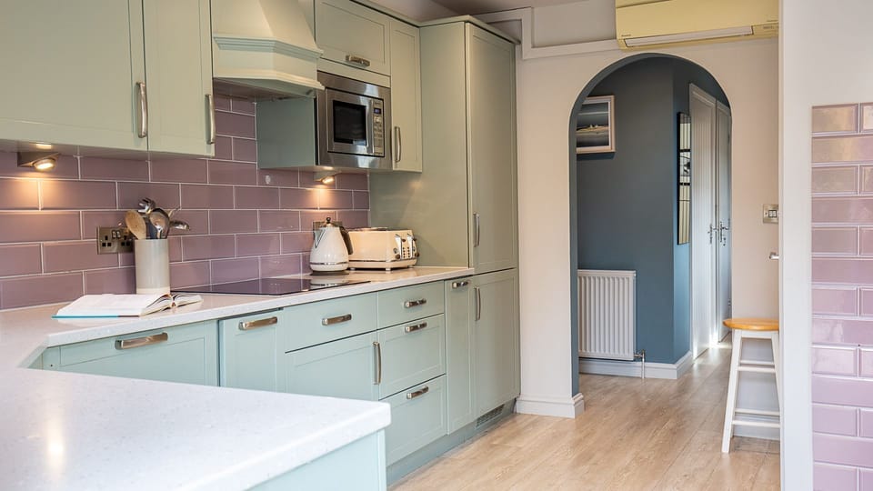 Hidden in a pantry cupboard are the laundry facilities which include a washing machine and tumble dryer.