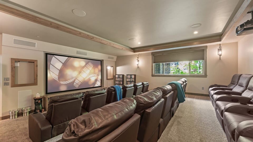 Theater room: Ground floor, 160" screen, leather recliners, DVD library, immersive sound system for cinematic experiences, lower floor