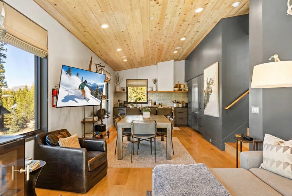 Living room (main floor): Wood-burning fireplace, Smart TV, mountain views
