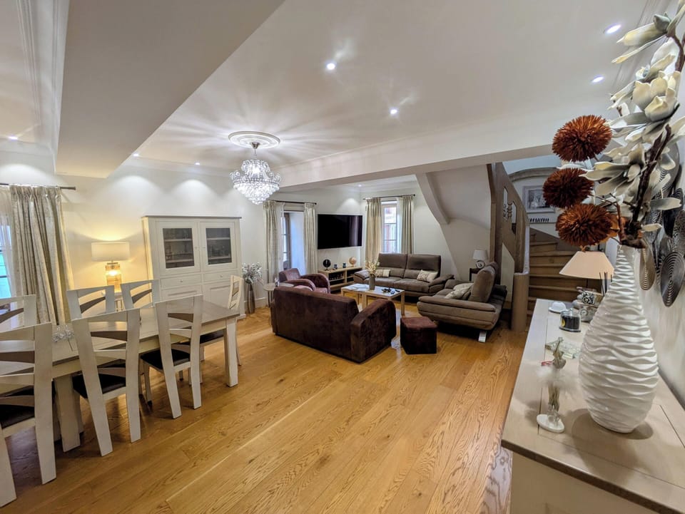 A large living room with Smart TV and sofas for relaxing