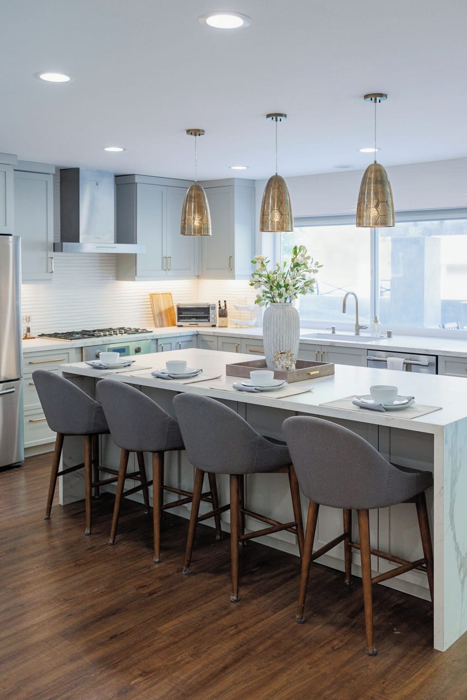 Kitchen features modern appliances and a breakfast bar.