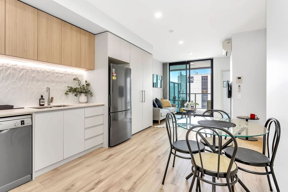 Bright, open-plan dining area adjacent to a modern kitchen.