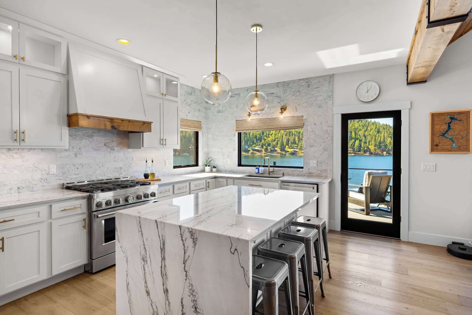 Wake up to this view — a chef’s kitchen where marble, sunlight, and lakefront serenity meet. Cook, connect, and savor every moment overlooking the sparkling waters of Powderhorn Bay.