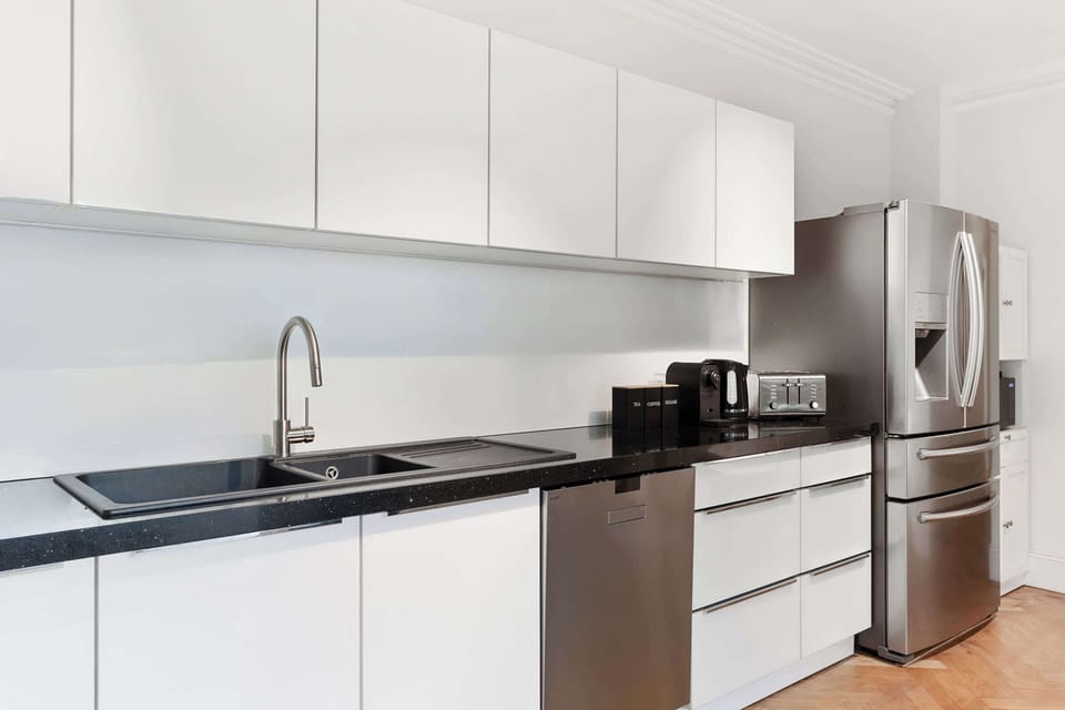 The modern kitchen comes fully equipped with everything you need for effortless cooking and entertaining. It offers direct access to the alfresco area, as well as a conveniently located bathroom, blending practicality with contemporary style.
