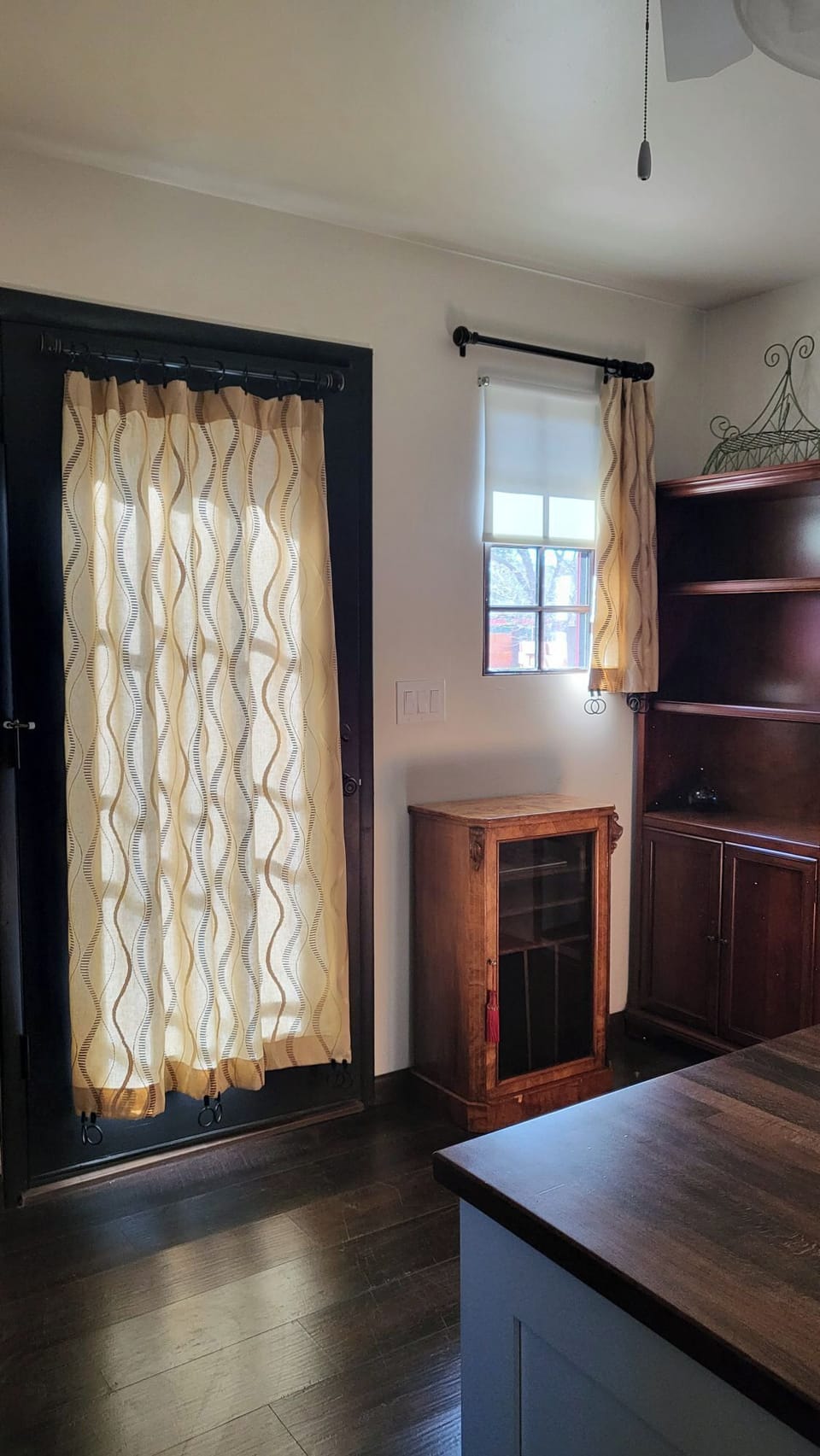 Private entry with elegant curtains and natural light for a warm, welcoming feel.