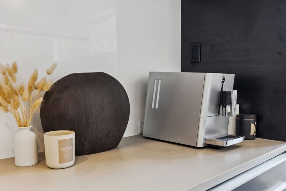 Wake to the scent of fresh coffee as you watch sunlight spill across stone counters and black oak cabinetry